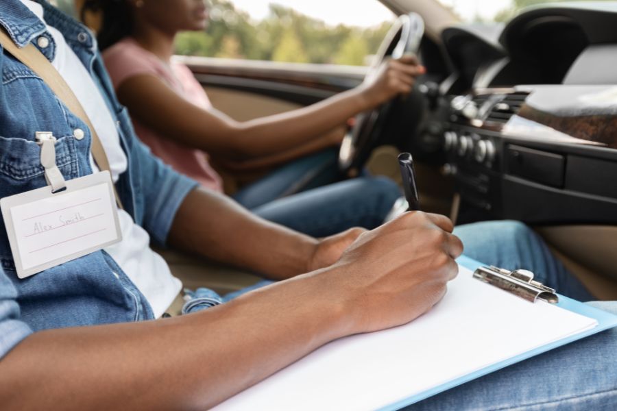 student practicing for drivers licence test with driving instructor