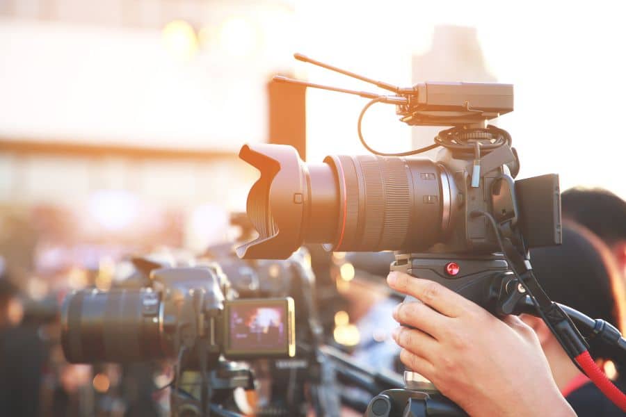 A person holding a news camera, highlighting the scarce skills in arts and media.