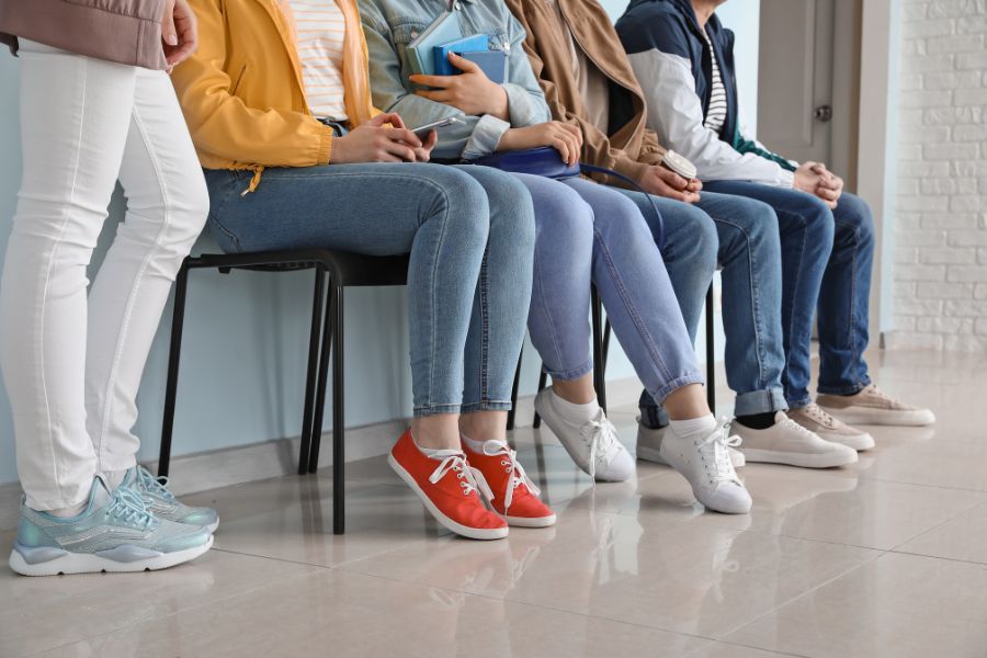 student waiting in a queue to collect driver's licence