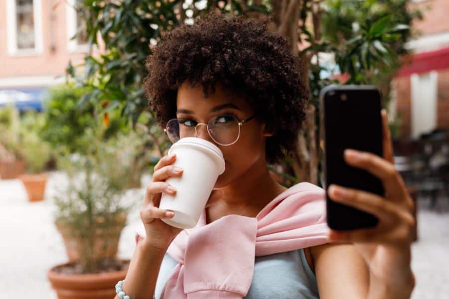 student drinking coffee at their part-time job