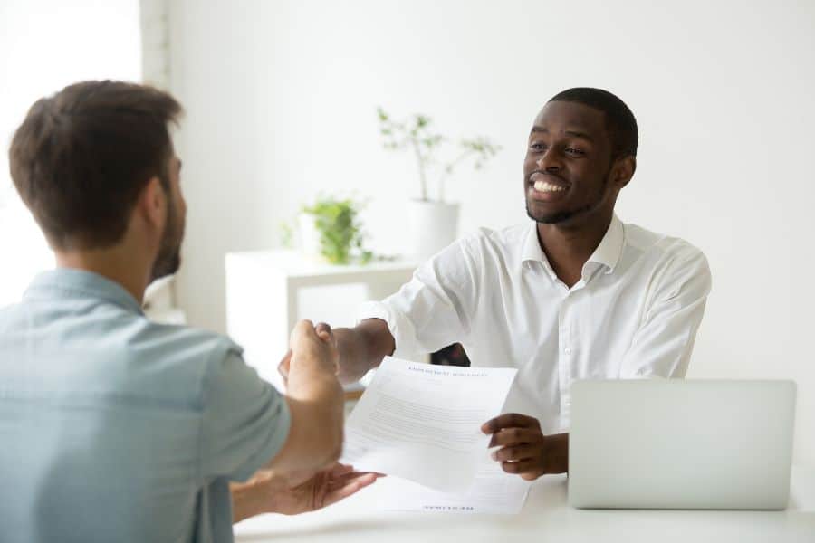 two people shaking hands after choosing the right job contracts