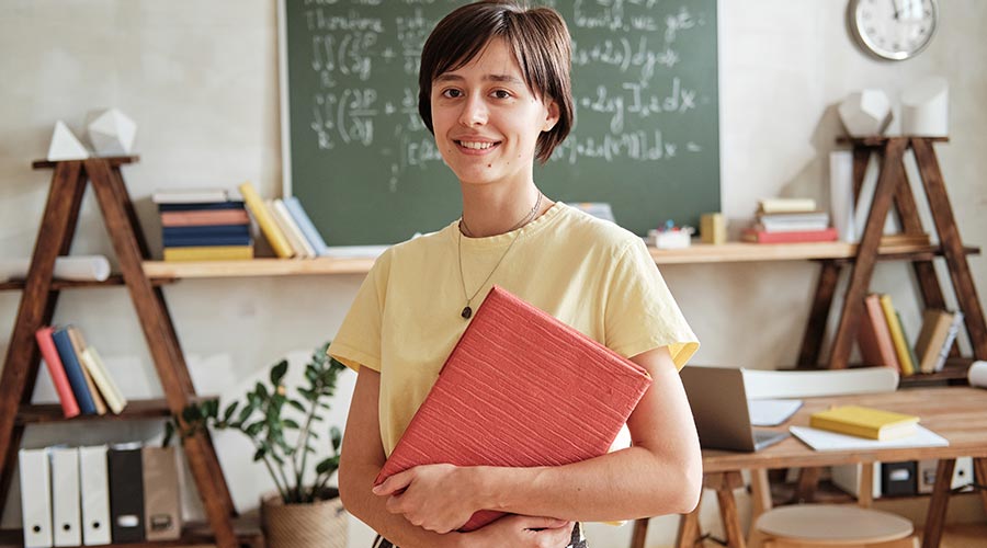Teacher holding textbook